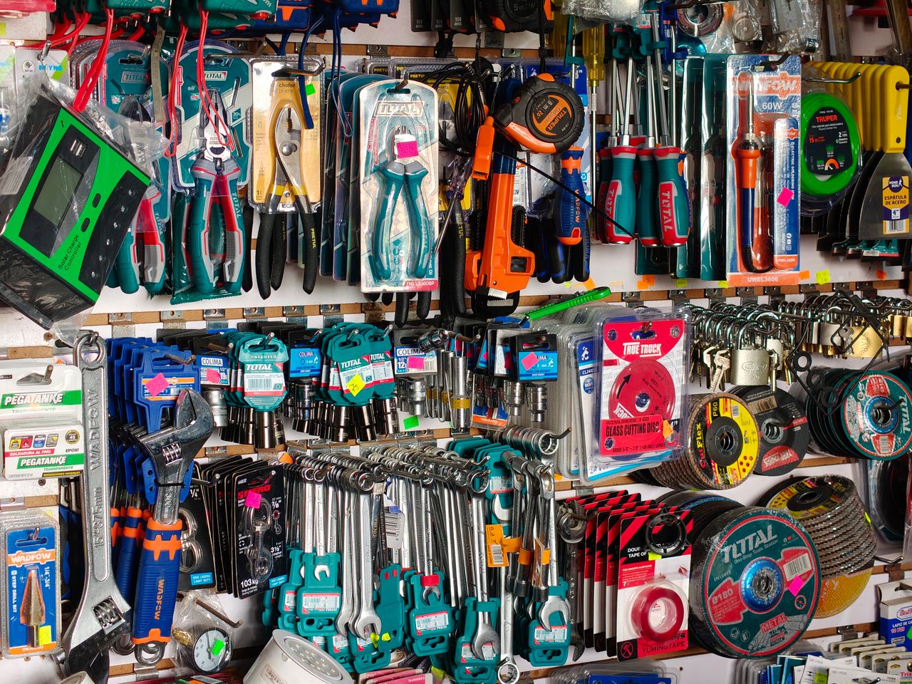 A comprehensive display of diverse hardware tools including pliers, screwdrivers, and wrenches in a store.